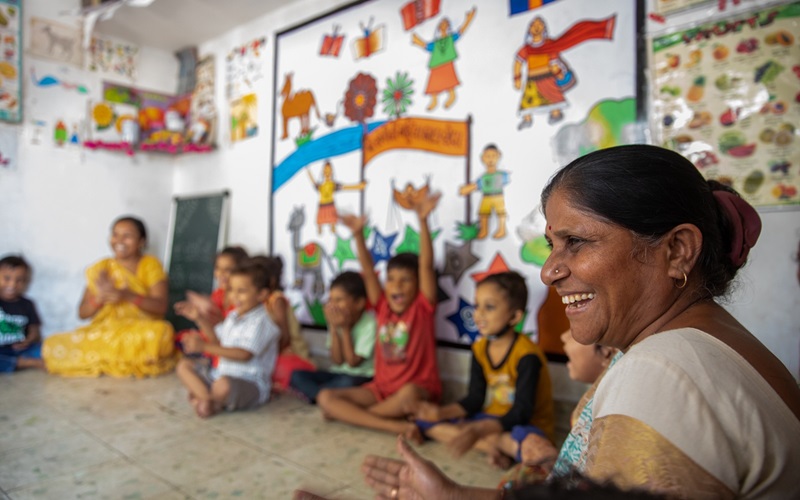 Jashodaben conducts various activities with children based on teacher training programs in a child care center known as crèche in Ahmedabad, Gujarat, India.