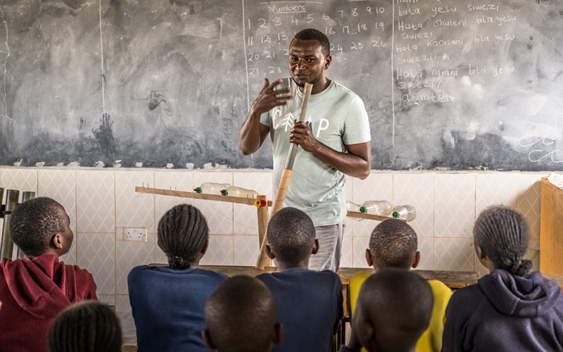 James Mutinda, a farmer, teaches music to students using recycled items for instruments at Lulu Light School in Machakos County, Kenya, on September 19, 2023.