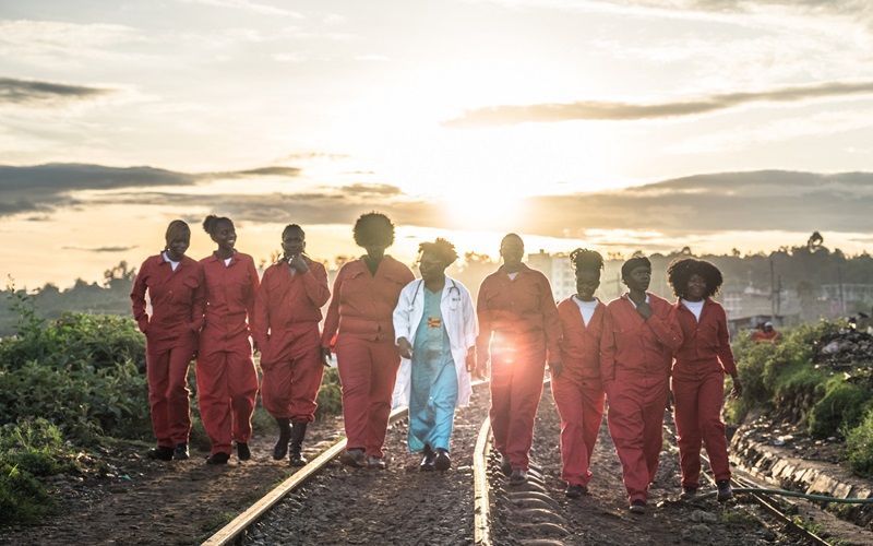 Dr. Stellah Bosire, centered, walks with members of the group Feminists for Peace, Rights and Justice Center in Kibera, Kenya. 