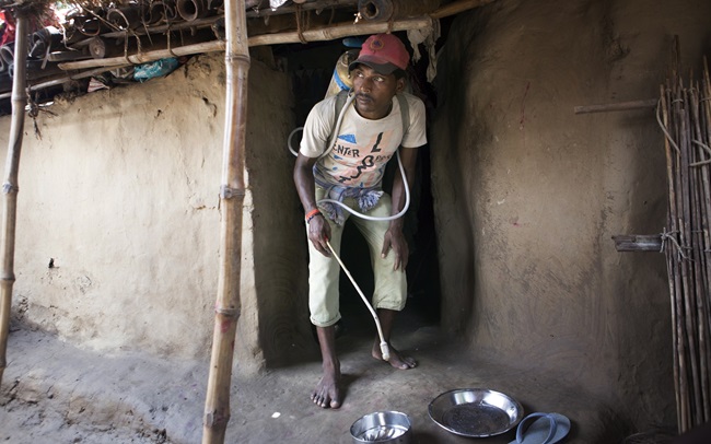 A worker sprays insecticide as part of a Government of Bihar initiative to eradicate black fever in Bihar, India, in 2015.