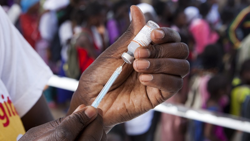 A health worker prepares a vaccine during a meningitis vaccination campaign in Kaolack, Senegal on November 14, 2012.