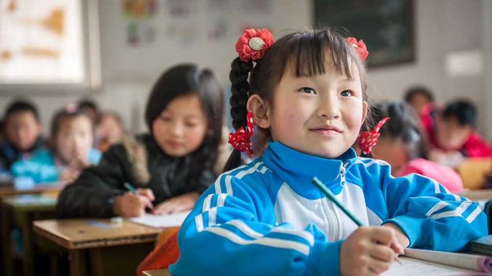 Students are busy in class at the Hua Ao School, located in Beijing, Shijingshan district on April 7, 2015. Founded in 1997 the school boards and educates nearly 900 students from low-income migrant parents at primary and middle school levels.