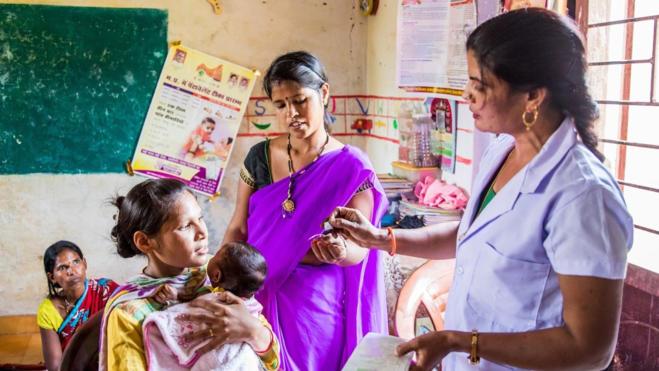 Gayatri Ahirwar, Auxiliary Nurse Midwife (ANM), explains the post care of the vaccinations given to a mother and child at an Anganwadi Centre (AWC) in Bhopal, Madhya Pradesh, India on September 26, 2018.